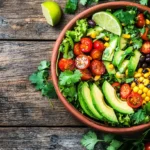 A colorful Mexican salad with fresh avocado, corn, and beans.