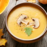 Creamy autumn squash soup in a cozy fall setting