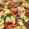 Classic pasta salad in a bowl with colorful vegetables and dressing